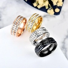Macro view of stainless steel rings in four colors featuring double-row zircon inlay