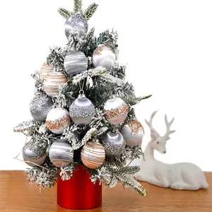 Set of 6cm/8cm painted foam Christmas balls with glitter and stripes on a snowy tree