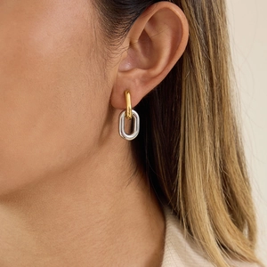 Two-tone gold and silver circular drop earrings in stainless steel on female model