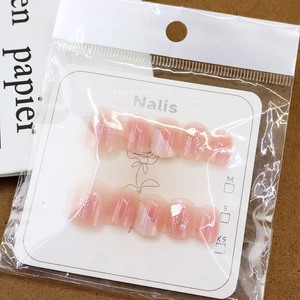 Handmade shimmer press-on nails with pink gradient design and pearl shell accents