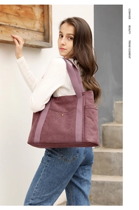 Lifestyle shot of a burgundy canvas tote bag with large capacity and dual shoulder straps