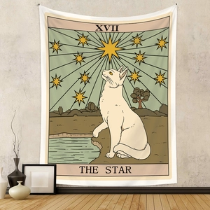 Detail of bohemian tapestry featuring a cat star tarot design on a textured white wall