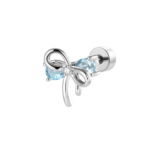 Silver bow stud earring featuring light blue gemstones and clear diamond on white background