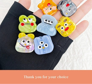 Detailed view of colorful acetate cartoon hair clips with marble texture in hand