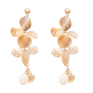 Bohemian gold earrings with sea shells and white stones on a clean white background