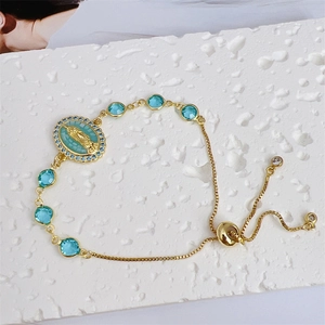 Macro shot of 18K gold plated adjustable slider bracelet with Virgin Mary cameo detail