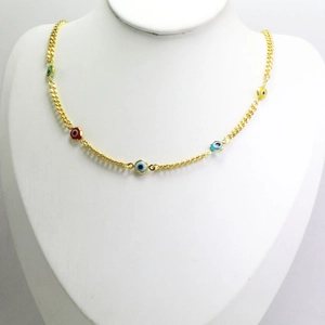 Close-up of golden necklace with colorful evil eye charms on a jewelry display