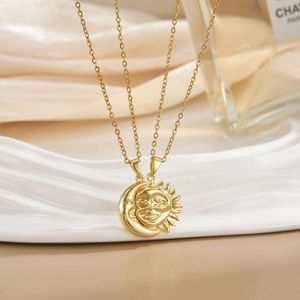 Detail of gold sun and moon necklaces with micro-pave zircon on wrinkled cream silk