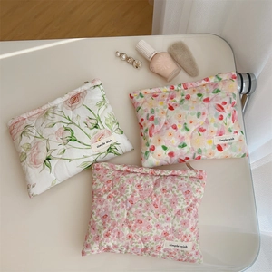 Three quilted floral cosmetic bags with zippers, pink rose and colorful patterns