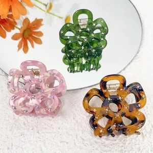 Floral acetate hair claw clips with rhinestones in green, pink, and tortoiseshell colors