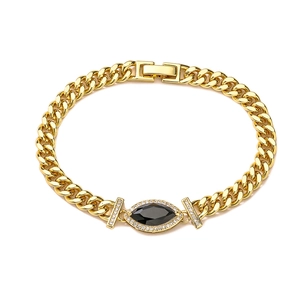 Close-up of gold plated Cuban chain bracelet with marquise black stone and white zircon