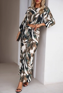Detail of a two-piece set featuring abstract print with puff sleeves and wide-leg trousers
