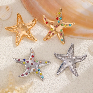 Starfish jewelry set in gold and silver finish with colorful rhinestones on beach sand