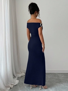 Detail of navy off-shoulder dress back with gold ring accents and slim fit cut