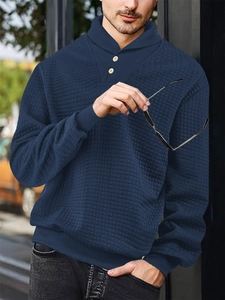 Detailed macro view of waffle texture fabric and wooden button collar on navy sweatshirt