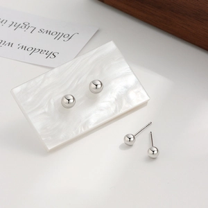 Minimalist S925 sterling silver ball stud earrings set in a high-polished metallic finish