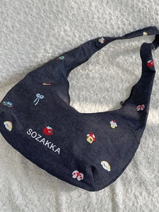 Denim half-moon hobo bag with colorful cartoon embroidery and white SOZAKKA text