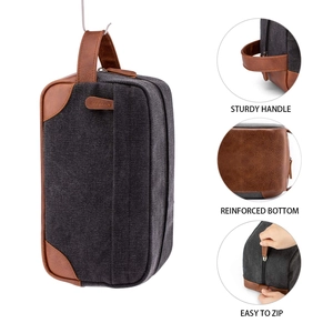 Detail view of men's canvas toiletry bag features sturdy handle and reinforced bottom