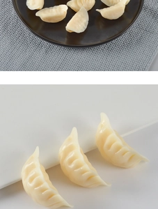 Close-up of realistic PVC dumpling models with detailed handmade texture on a plate