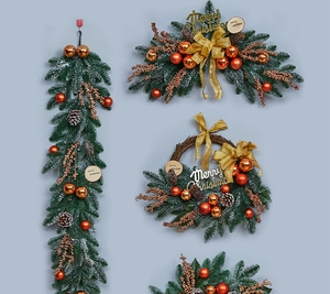 Detailed close-up of pine branches, bronze ornaments and gold Merry Christmas signs