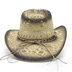 Detail of hollow woven straw cowboy hat showing texture and brown decorative bow