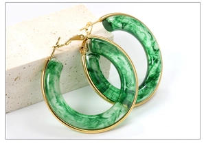 Detailed macro view of large green marble resin hoop earrings with gold-plated accents