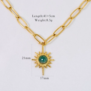 Macro detail of gold sunburst pendant necklace with green stone and chain dimensions