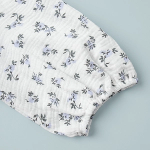 Detailed macro view of puff sleeves with elastic cuffs on a blue floral cotton dress