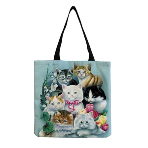 Close-up of black cat and kittens print on light blue cotton linen tote bag texture