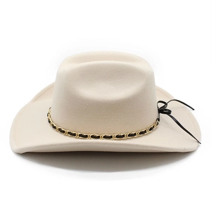 Detail of cream felt fedora hat featuring black and gold braided chain with side ribbon