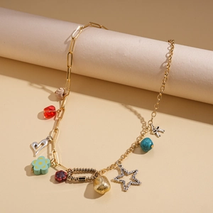 Detail of boho gold chain necklace with colorful resin beads and floral charms