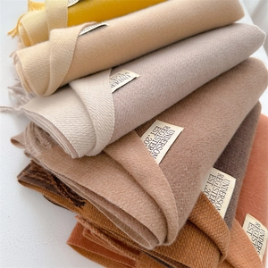 Folded winter cashmere-feel scarves in multi-color stacked layout with soft knit texture
