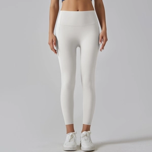 Close-up of white high-waisted yoga leggings showing elastic fabric and seam details