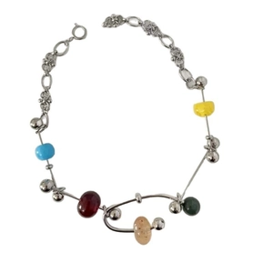 Handmade mixed media necklace with silver chains and colorful beads in a minimalist style