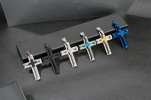 Detail view of multi-color stainless steel cross pendants with layered hollow design