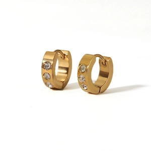 Detailed macro view of 18K gold plated huggie earrings with three round zircon stones