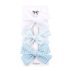 Three-piece fabric bow hair clip set with dots, hearts, and plaid patterns for girls