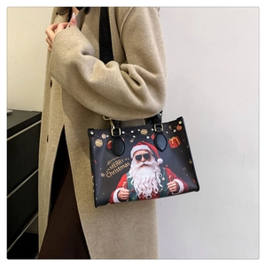 Detail of Christmas tote bag with Santa print and gold hardware shown on a beige coat