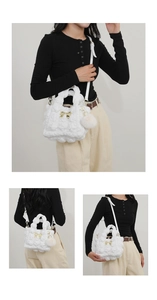 Detail view of white quilted cloud bag with gold bow and plush charm on female model