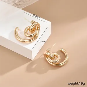 Detailed view of irregular waterdrop gold earrings with hollow twist design and 25mm diameter