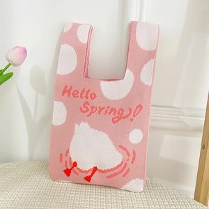 Detail of pink knitted tote bag with cute duck illustration and Hello Spring text
