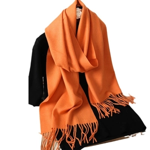 Solid orange cashmere-feel scarf with elegant tassels for autumn and winter warmth