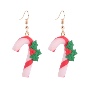 Detailed view of candy cane Christmas earrings with holly leaves on white background