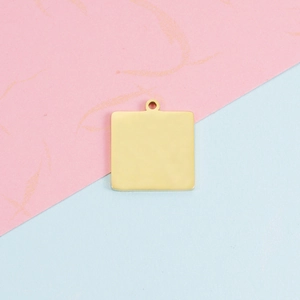 Close-up of 18mm square gold stainless steel pendant for DIY jewelry and engraving