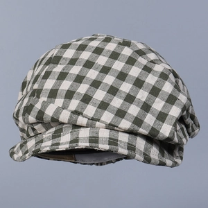Close-up of green and white plaid linen flat cap showing breathable fabric texture