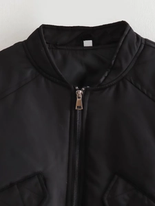Detail of metal zipper and stand collar on a black polyester flight bomber jacket