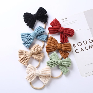 Macro shot of 7-color knit bow headbands in soft Morandi tones for baby fashion