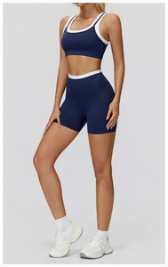Detail showing the contrast trim and ribbed texture of a navy blue sports yoga set