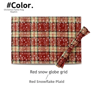 Detail view of red plaid Christmas table runner with snowflake prints and rolled fabric texture