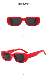 Macro detail of retro red rectangle sunglasses with thick frame and dark grey lenses